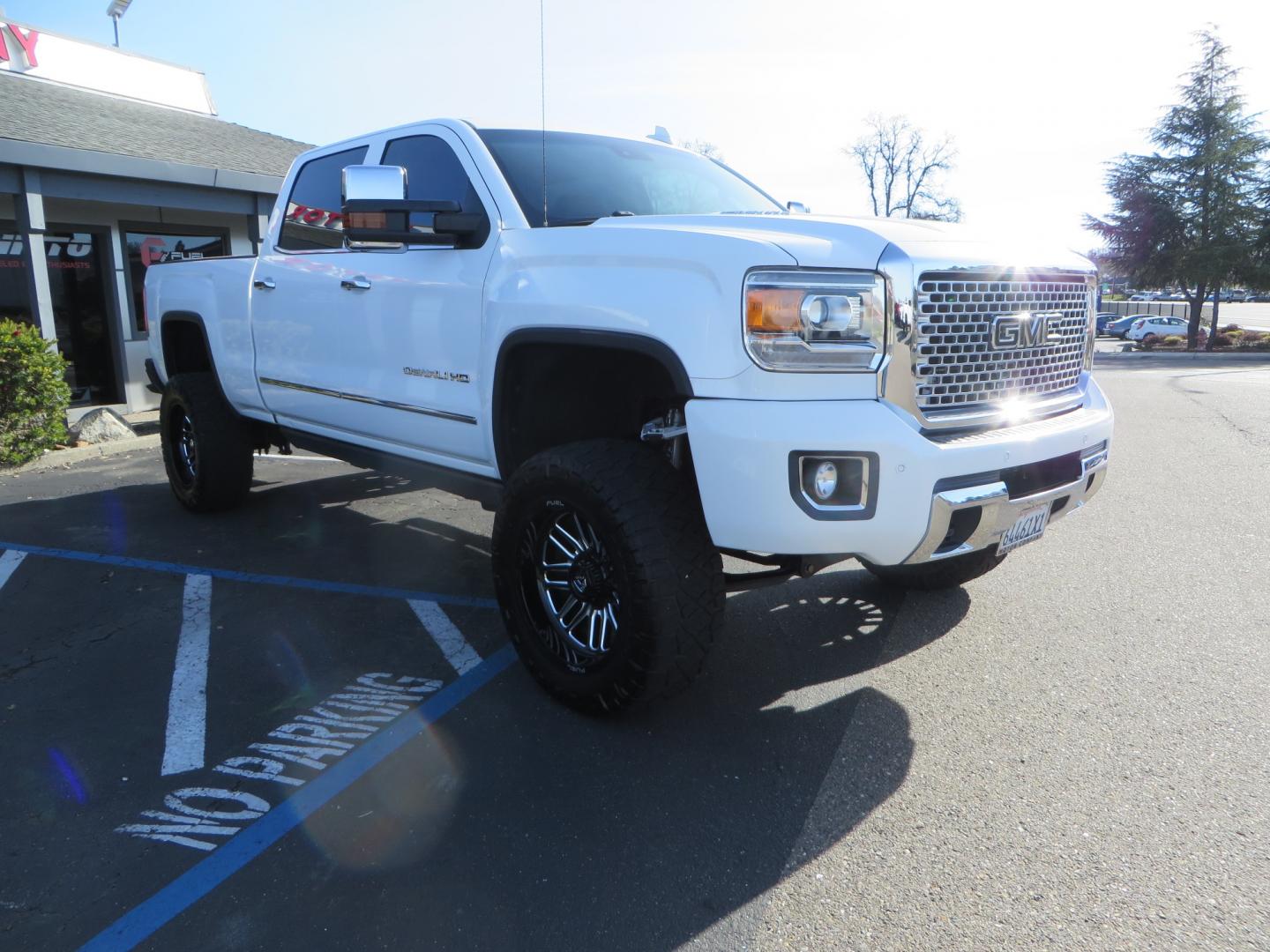 2015 White GMC Sierra 2500 HD Crew Cab Denali (1GT120E88FF) with an V8 Turbo Dsl 6.6L engine, Auto 6-Spd Allison OD transmission, located at 2630 Grass Valley Highway, Auburn, CA, 95603, (530) 508-5100, 38.937893, -121.095482 - 2015 GMC Denali 2500 6.6L Duramax Diesel. Cognito 4-6" lift kit, Cognito traction bars, Cognito idler and pitman support, Kryptonite upper control arms, Fox remote reservoir shocks, Amp power steps, Fuel Offroad wheels, Nitto Ridge Grappler tires, Alpine Stereo Firestone ride rite air bags, Transfer - Photo#2